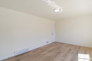 Spare room with light wood-style flooring