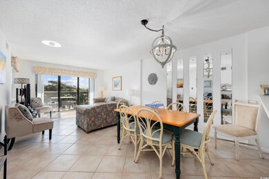 Dining room featuring a textured ceiling, light tile patterned flooring, and a chandelier