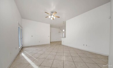 Empty room featuring ceiling fan and light tile flooring