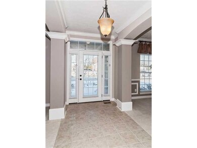 Entry. Tiled entry, columns, arches, crown molding, 9  ceilings