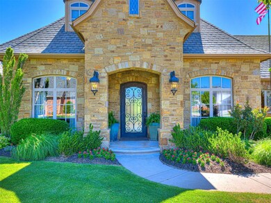 Entrance to property with stone siding, a lawn, and a high end roof