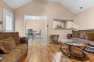 Living room with vaulted ceiling, an inviting chan
