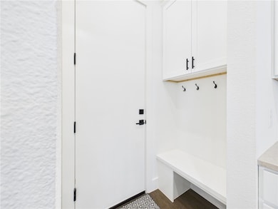Mudroom featuring dark wood-style flooring