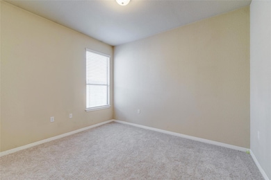 Carpeted spare room featuring healthy amount of n