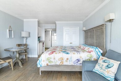 Bedroom with wood-type flooring, white fridge, a c