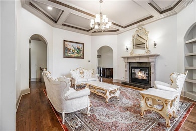 Living room featuring coffered ceiling, wood finis