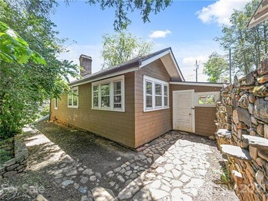 Side yard with unique stone patio and wall.