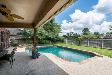 The covered patio has recessed lighting and a ceiling fan.  The saltwater pool and spa will provide hours of fun!  Plenty of yard left for the kids and dogs to run around!