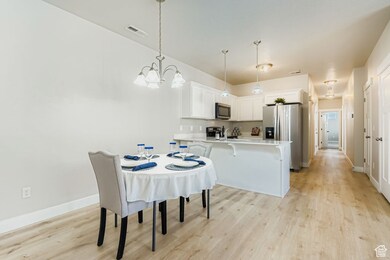 Kitchen with stainless appliances, microwave, range, refrigerator  and quartz counters