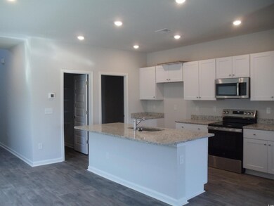 Kitchen featuring stainless steel appliances, whit