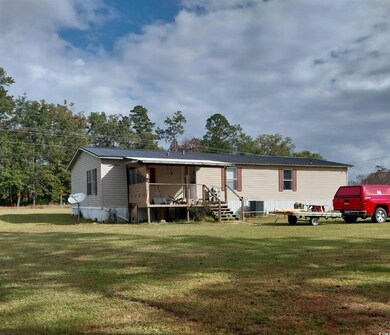 Rear view of house with a yard