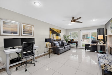 Home office with light tile patterned floors, a fireplace, ceiling fan, and recessed lighting