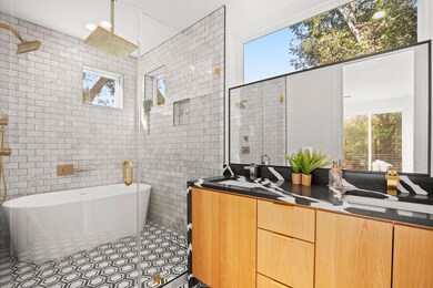 Full bathroom featuring tile walls, a freestandin
