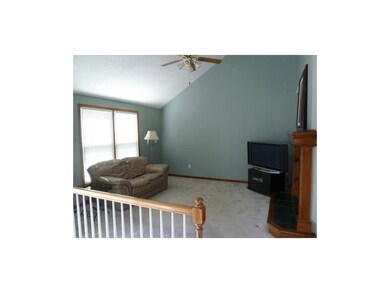 Great Room with vaulted ceiling and fireplace.