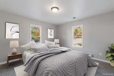 Carpeted bedroom with baseboards