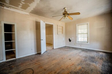 Unfurnished bedroom featuring ceiling fan and wood-type flooring
