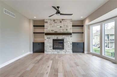 Stone fireplace in greatroom with builtins