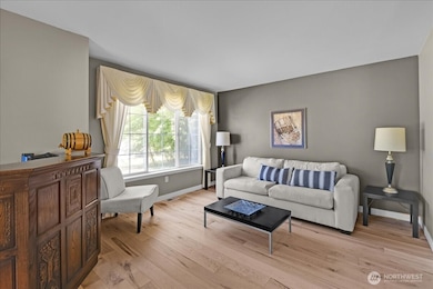 Formal Living Room. Gorgeous new maple floors and picture windows that overlook naturally landscaped side yard.