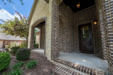 Doorway to property featuring brick siding
