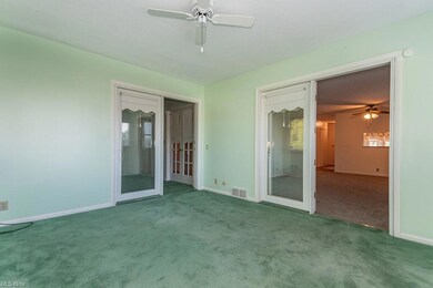 Spare room featuring ceiling fan, carpet floors, a