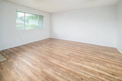 Unfurnished room with light wood-type flooring and baseboards