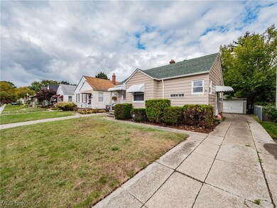 View of front of property with a front yard and a garage