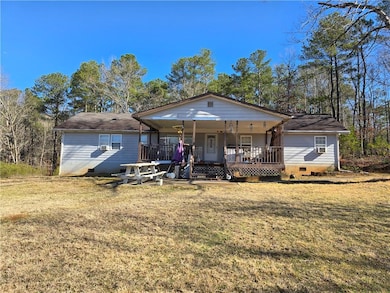 View of front facade featuring crawl space, a front yard, and a porch