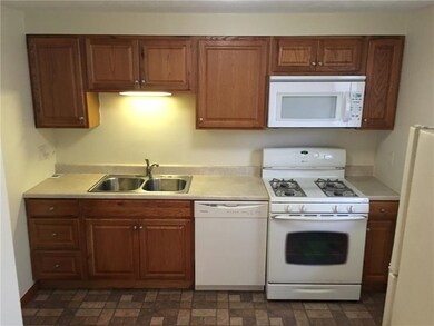 The kitchen has newer maple cabinetry, newer count