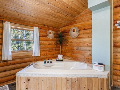 Bathroom with a washtub, vaulted ceiling, wooden c