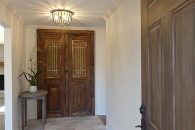 Inviting Front Entry Hall features a set of antiqu