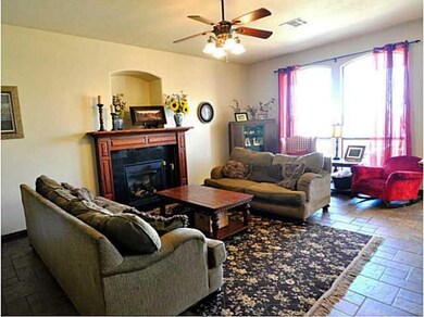 Living Room. Tiled living room with soaring ceilings, fireplace, and flooding with sunlight!
