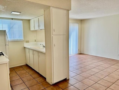 Kitchen with light countertops, freestanding refr