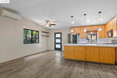 Kitchen featuring dark wood-style floors, light countertops, healthy amount of natural light, and recessed lighting