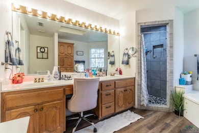 Bathroom featuring a shower with curtain, hardwood