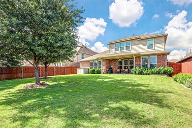 Back of house with a patio, a storage unit, and a 