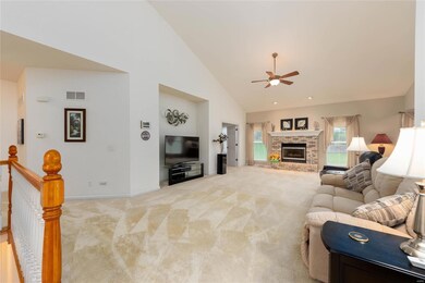 Valuted ceilings, gas fireplace, open floor plan.