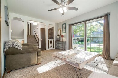 Living room view! Ceiling fan, large windows bring