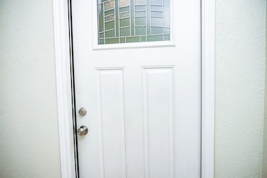 Property entrance with stucco siding