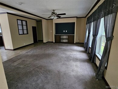 Living room featuring ceiling fan and a textured c
