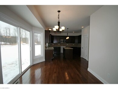 Kitchen boasts hardwood floors, granite counters, 