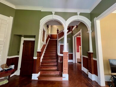 Stairs featuring a wainscoted wall, ornamental mol
