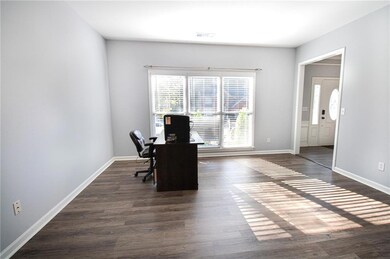 Office area featuring dark wood finished floors and baseboards