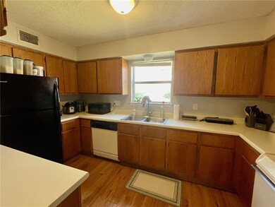 Kitchen featuring visible vents, light wood finish