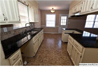 Kitchen features Granite Countertops, Tile Backspl