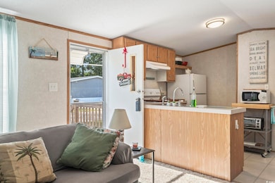 Kitchen featuring lofted ceiling, light tile patte