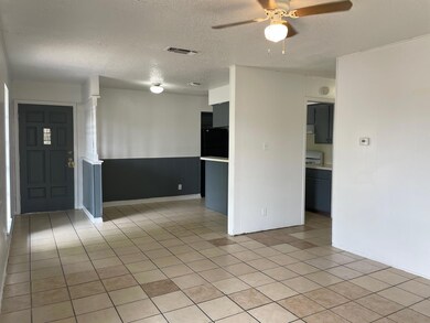 Empty room with visible vents, a textured ceiling