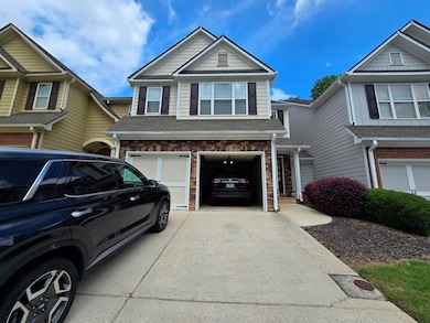 View of front facade featuring concrete driveway and an attached garage
