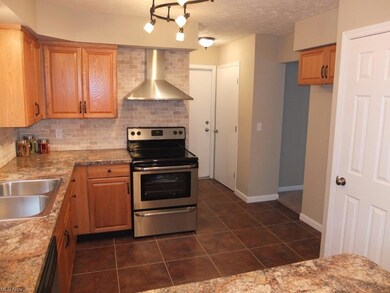 Remodeled kitchen with tile floor.