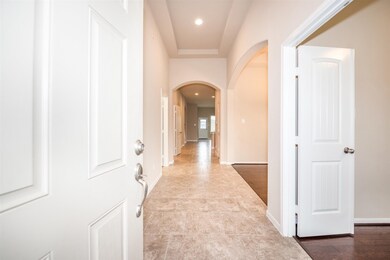 Upon entry, you and your guests will be greeted by this lovely hallway with tray ceiling, tile flooring and views to the back of the house.