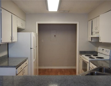 Kitchen with white appliances, under cabinet rang